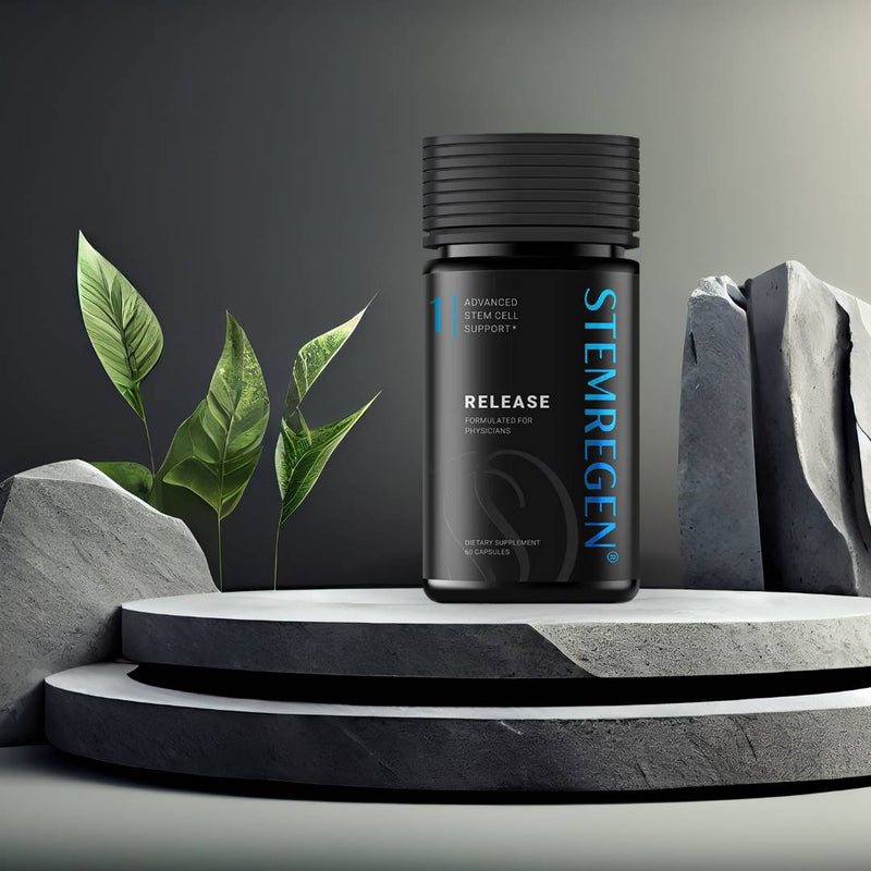 STEMREGEN Release supplement bottle displayed on a modern stone platform with greenery, promoting stem cell support and healthy aging